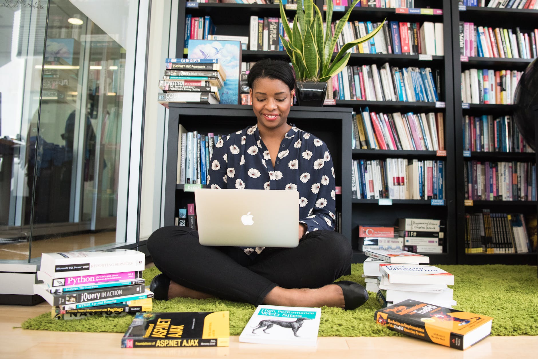 woman in black shirt using macbook