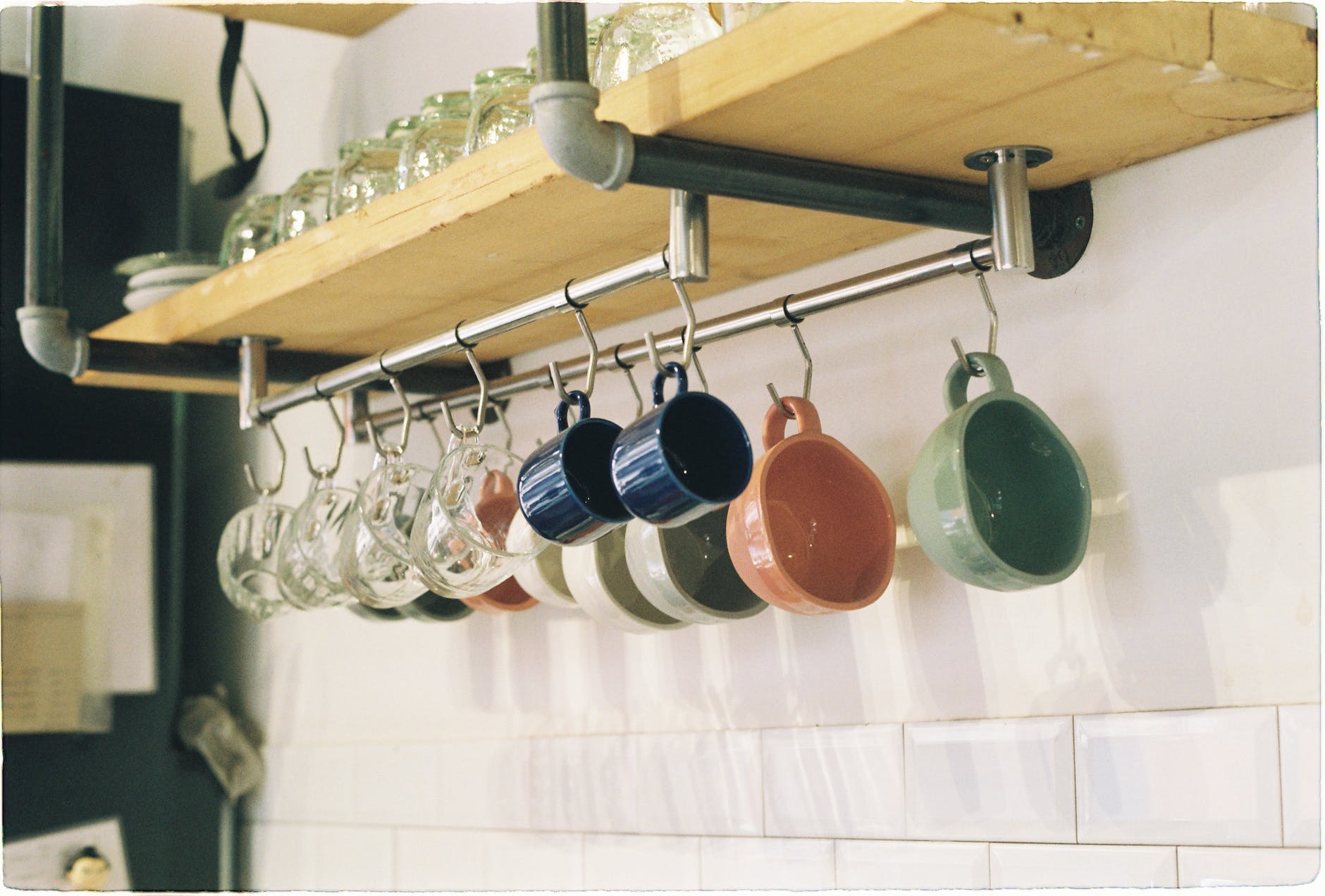 mugs hanging on shelf on home kitchen