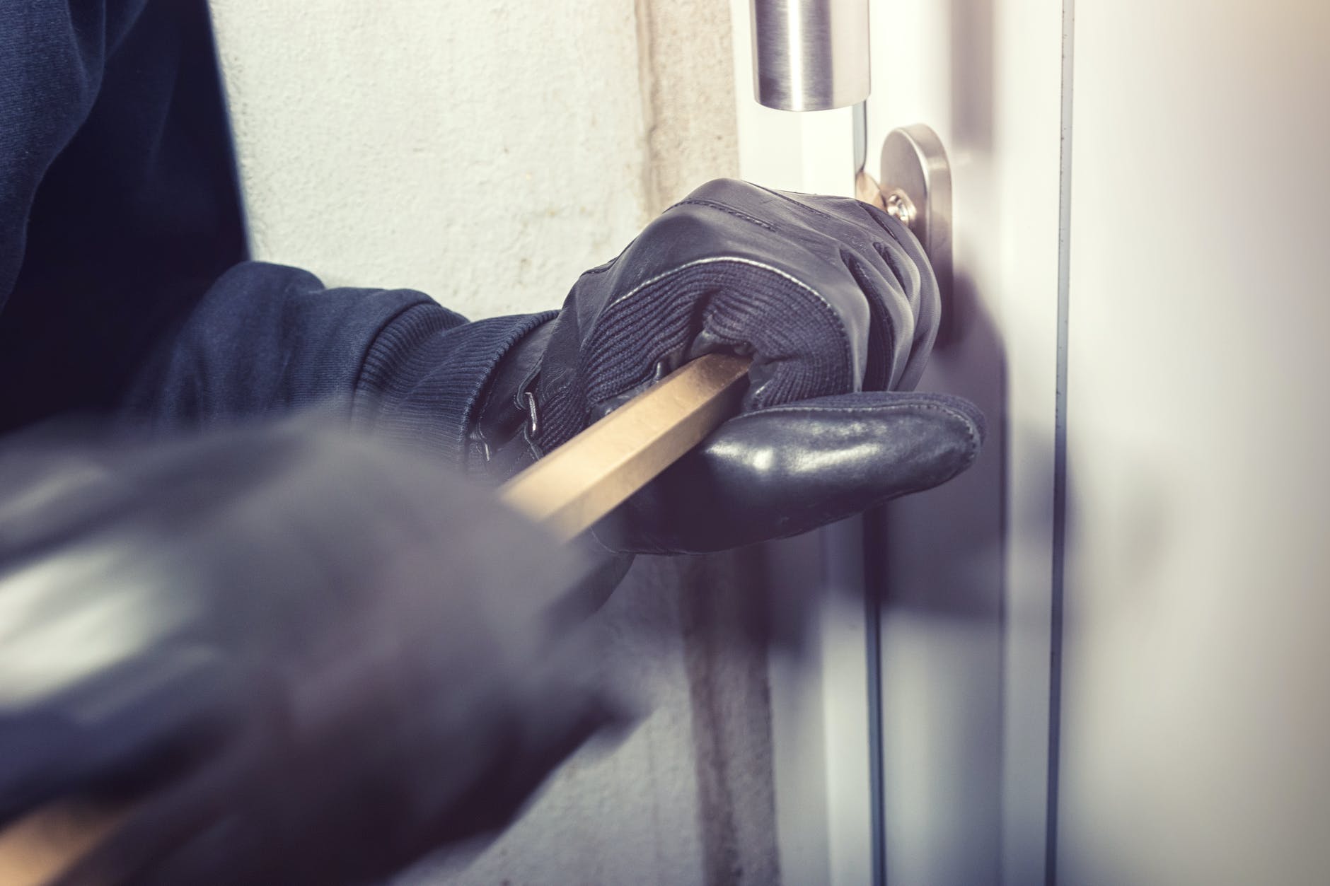 person opening a door with a bar